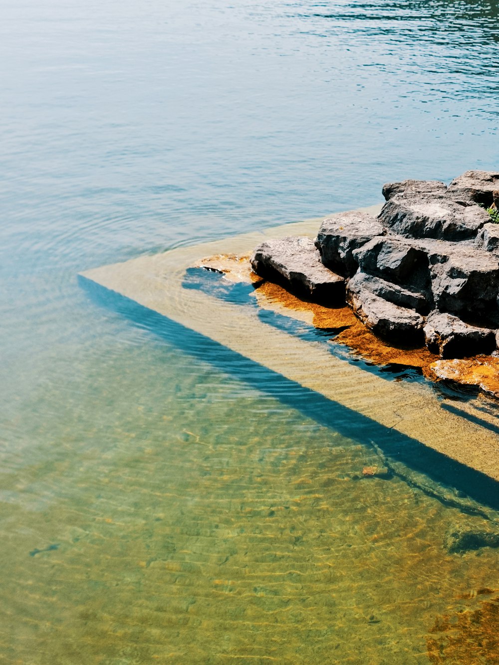 a large body of water with rocks in it