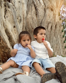 A cheerful group of children enjoying lollipops in a sunny park.