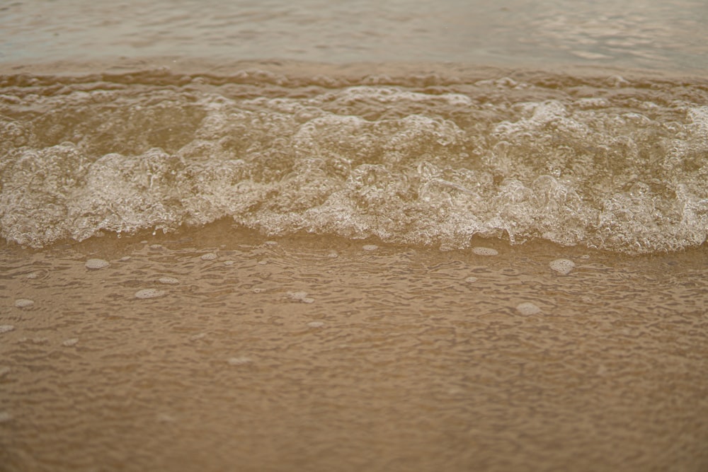 a close up of a wave coming in to the shore