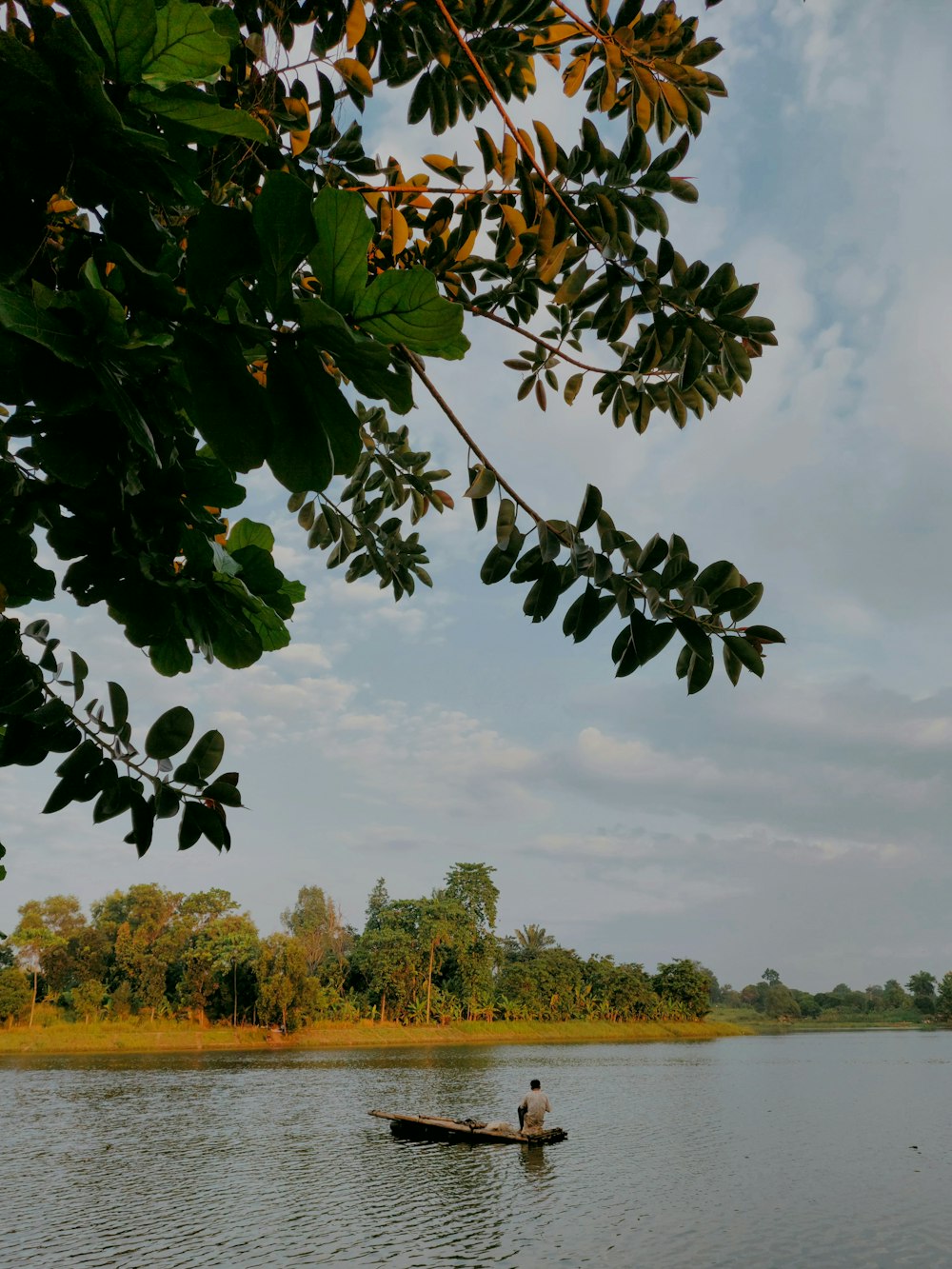 a person in a small boat on a body of water