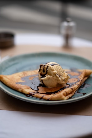 a blue plate topped with a scoop of ice cream
