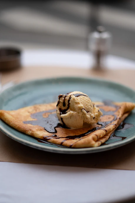 a blue plate topped with a scoop of ice cream