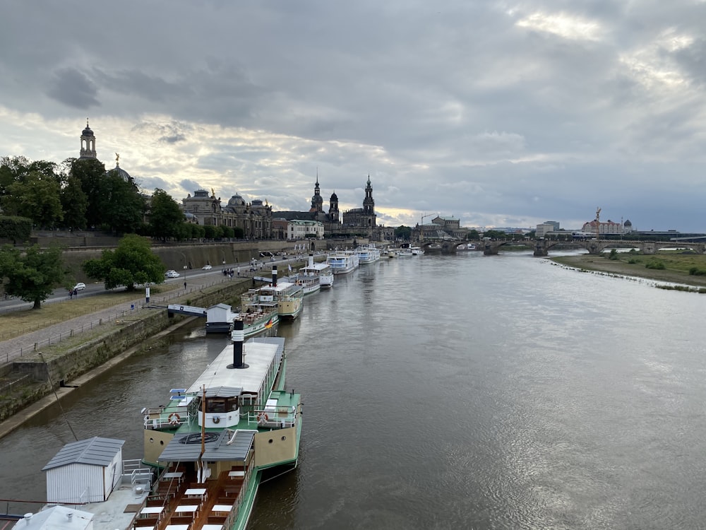 a river filled with lots of boats under a cloudy sky