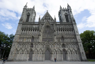 a large cathedral with a massive clock on it's side