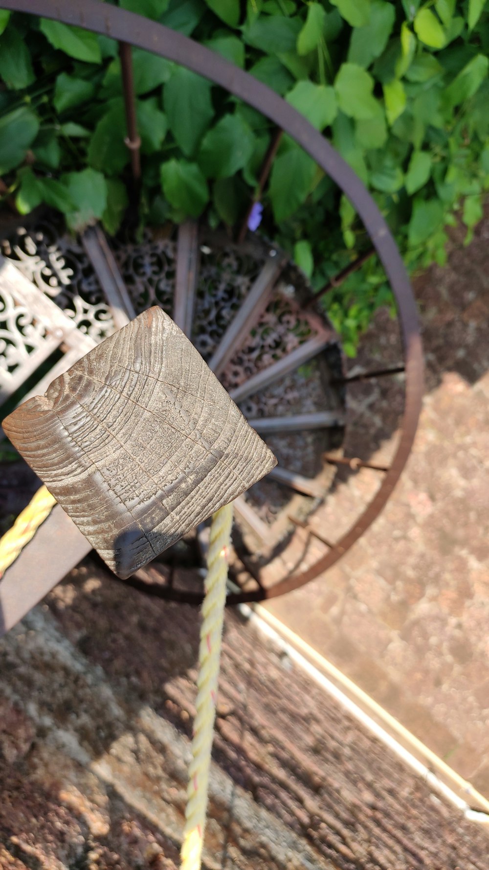 a close up of a wooden wheel on a bench