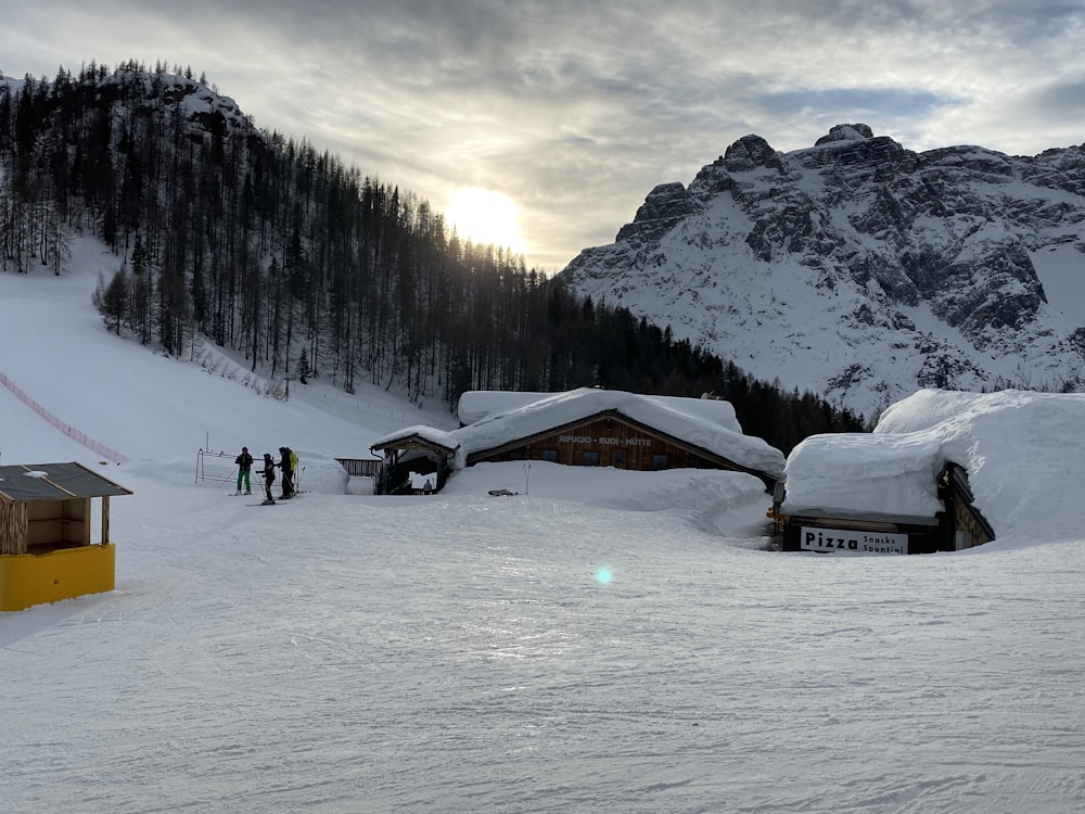 a group of people standing on top of a snow covered slope