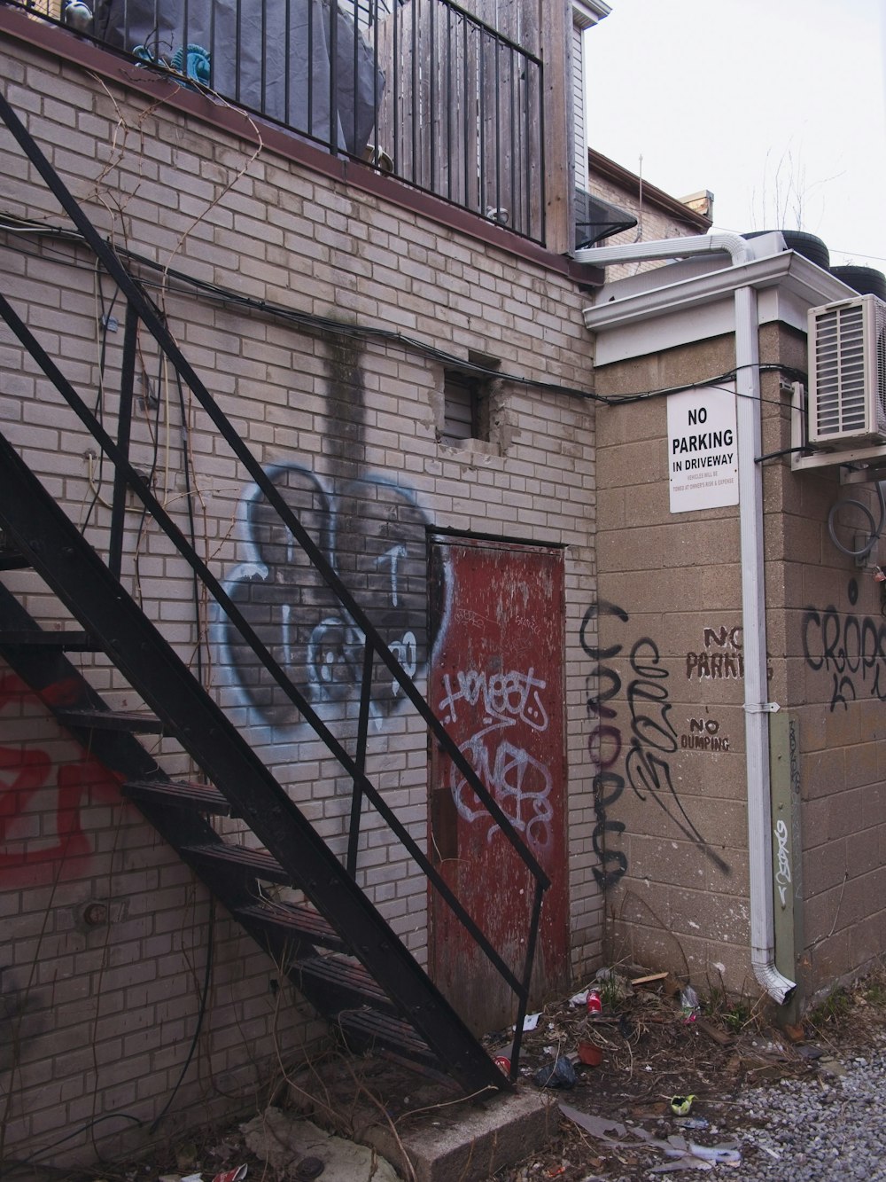 a brick building with graffiti on the side of it