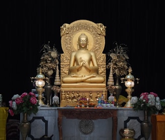 a golden buddha statue sitting on top of a table