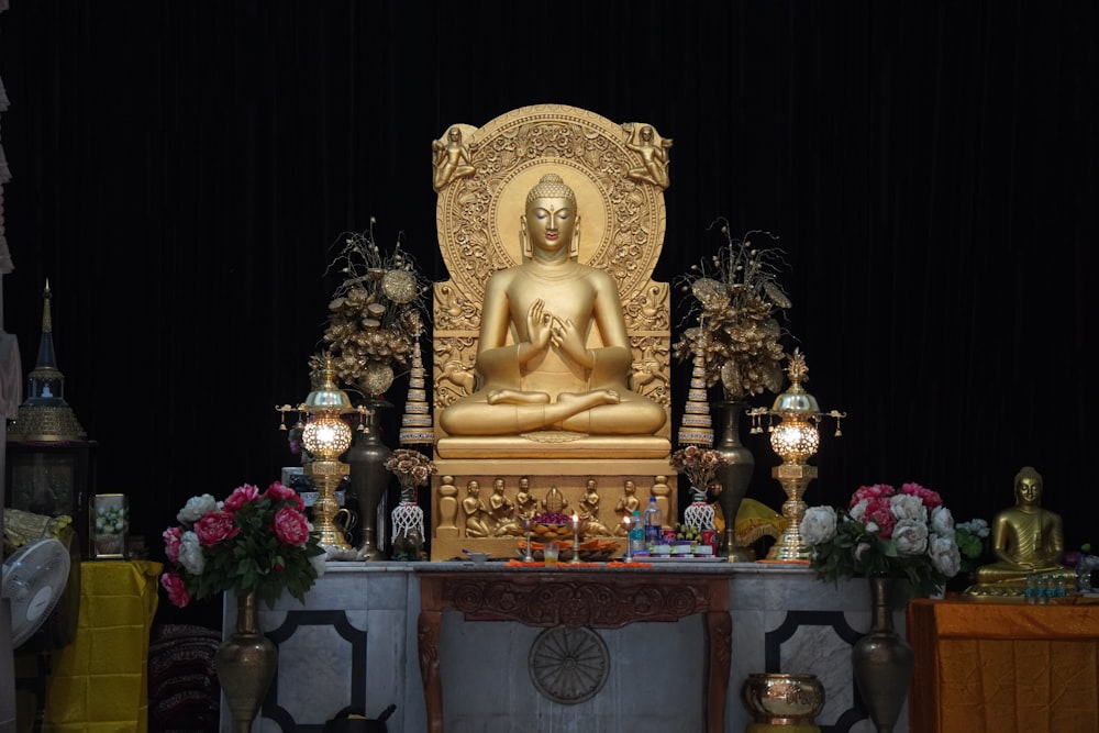 a golden buddha statue sitting on top of a table