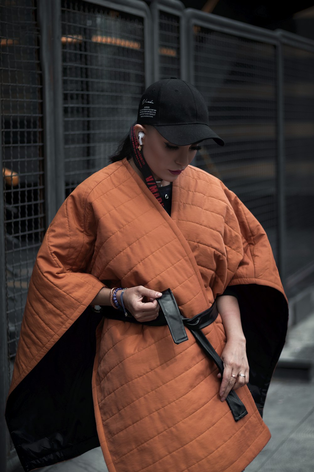 a woman in an orange kimono and a black hat
