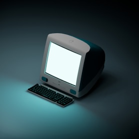 a computer with a white screen sitting on a table