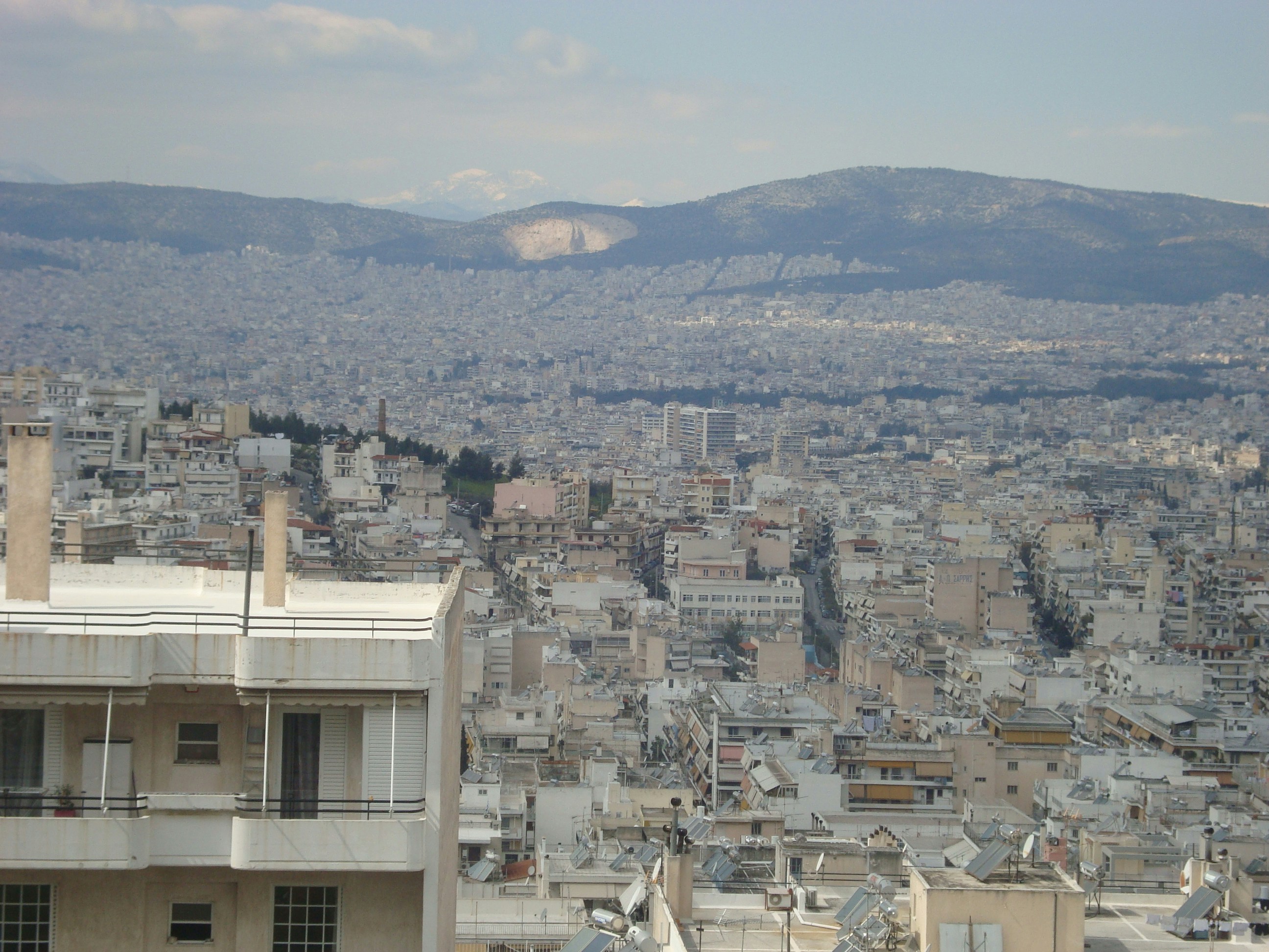 a view of a city with mountains in the background