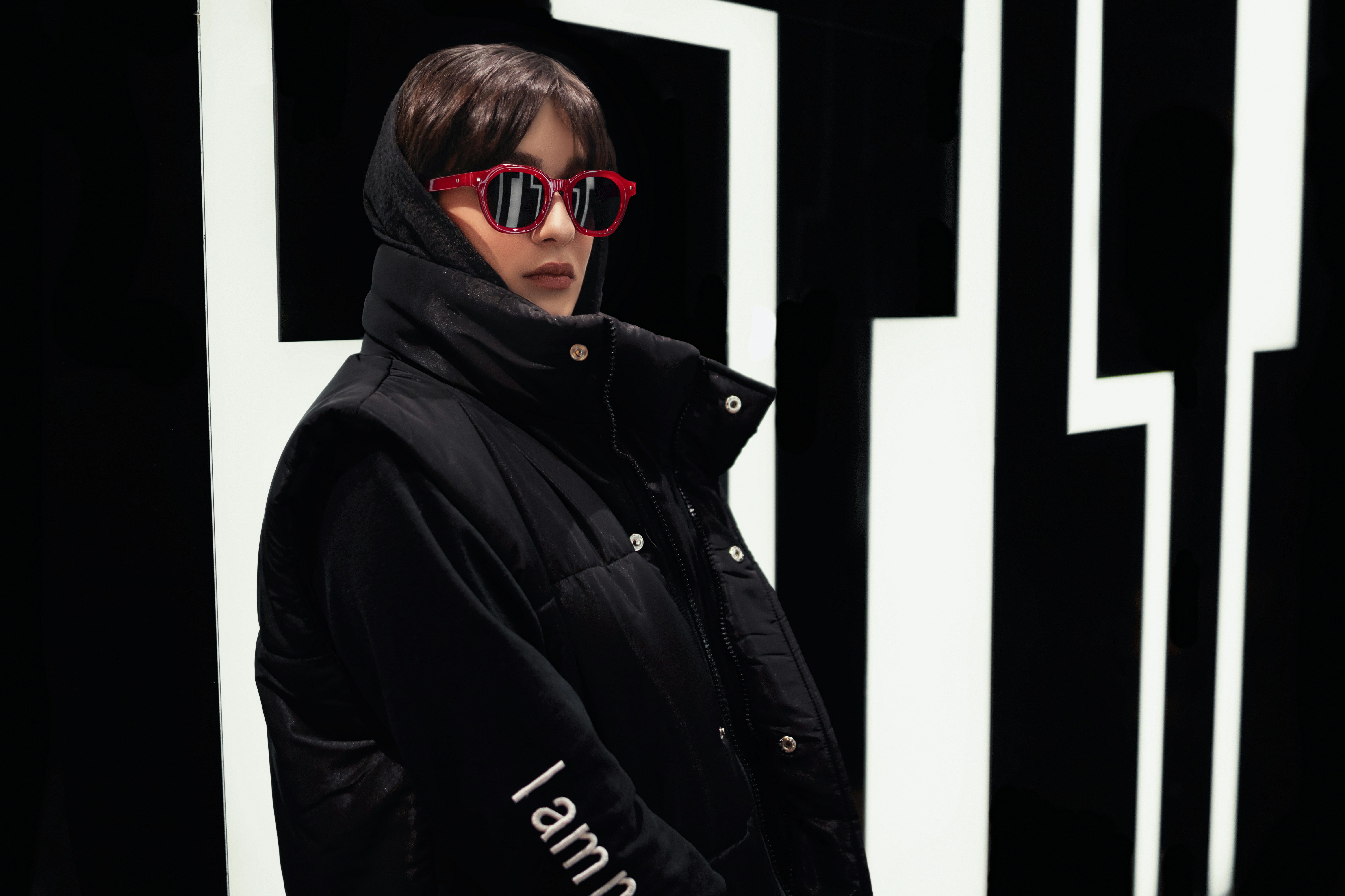 a person wearing sunglasses and a black jacket