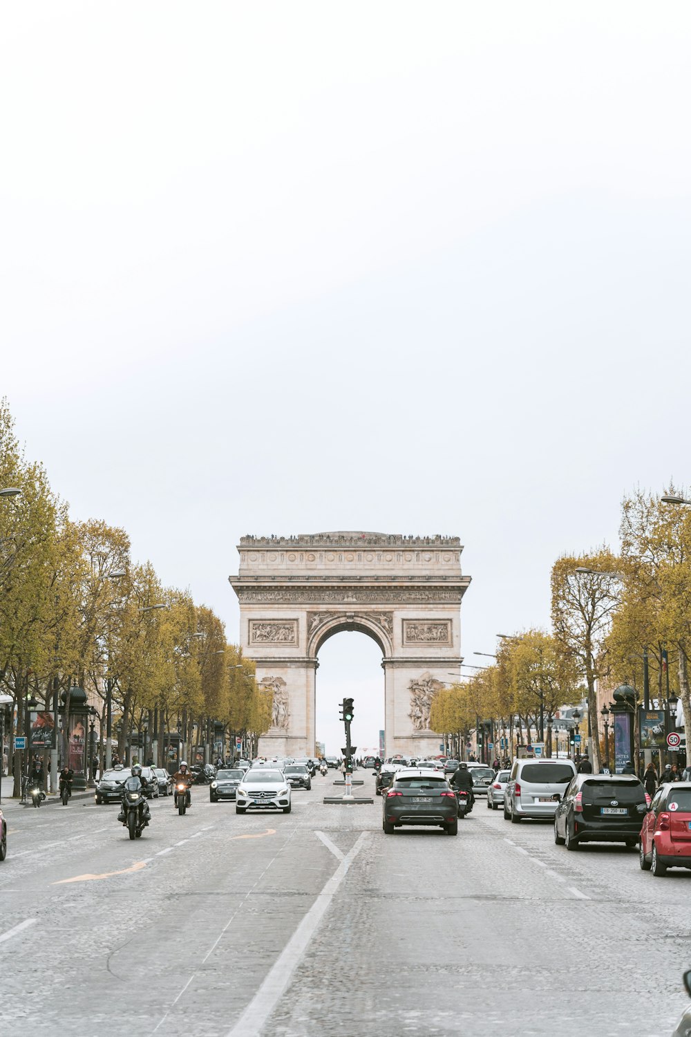 a busy city street with cars and motorcycles