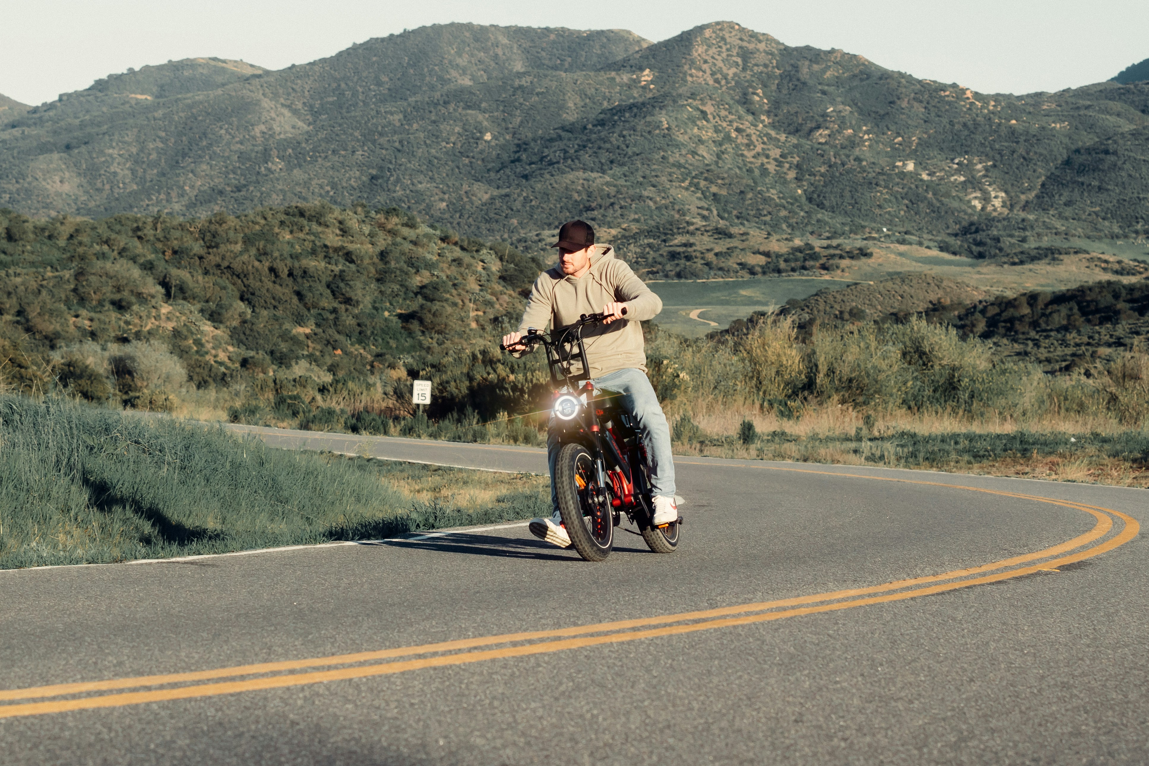 a man riding a bike down a curvy road