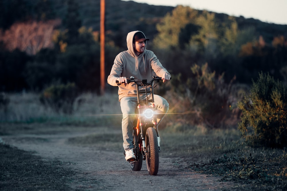 a man riding a motorcycle down a dirt road