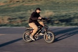 a man riding a bike down a street