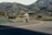 A happy customer riding a Honda motorcycle on a scenic road.