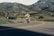 A happy customer riding a Honda motorcycle on a scenic road.