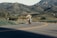 A happy customer riding a Honda motorcycle on a scenic road.
