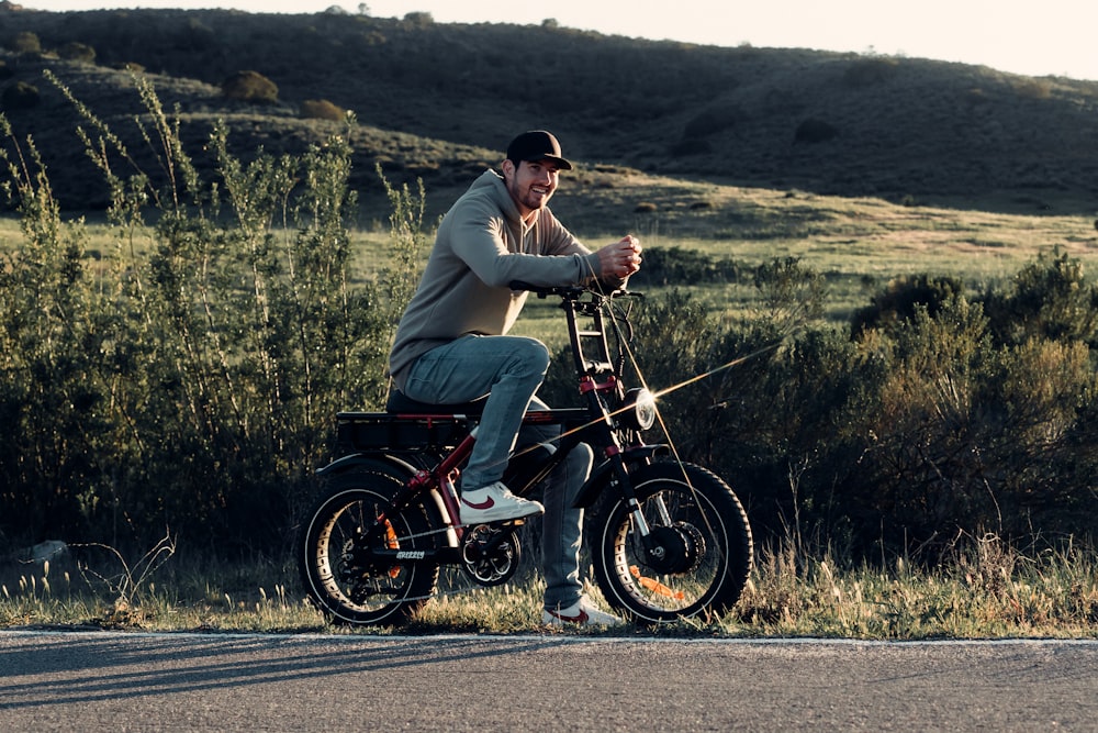 a man riding a motorcycle on the side of a road