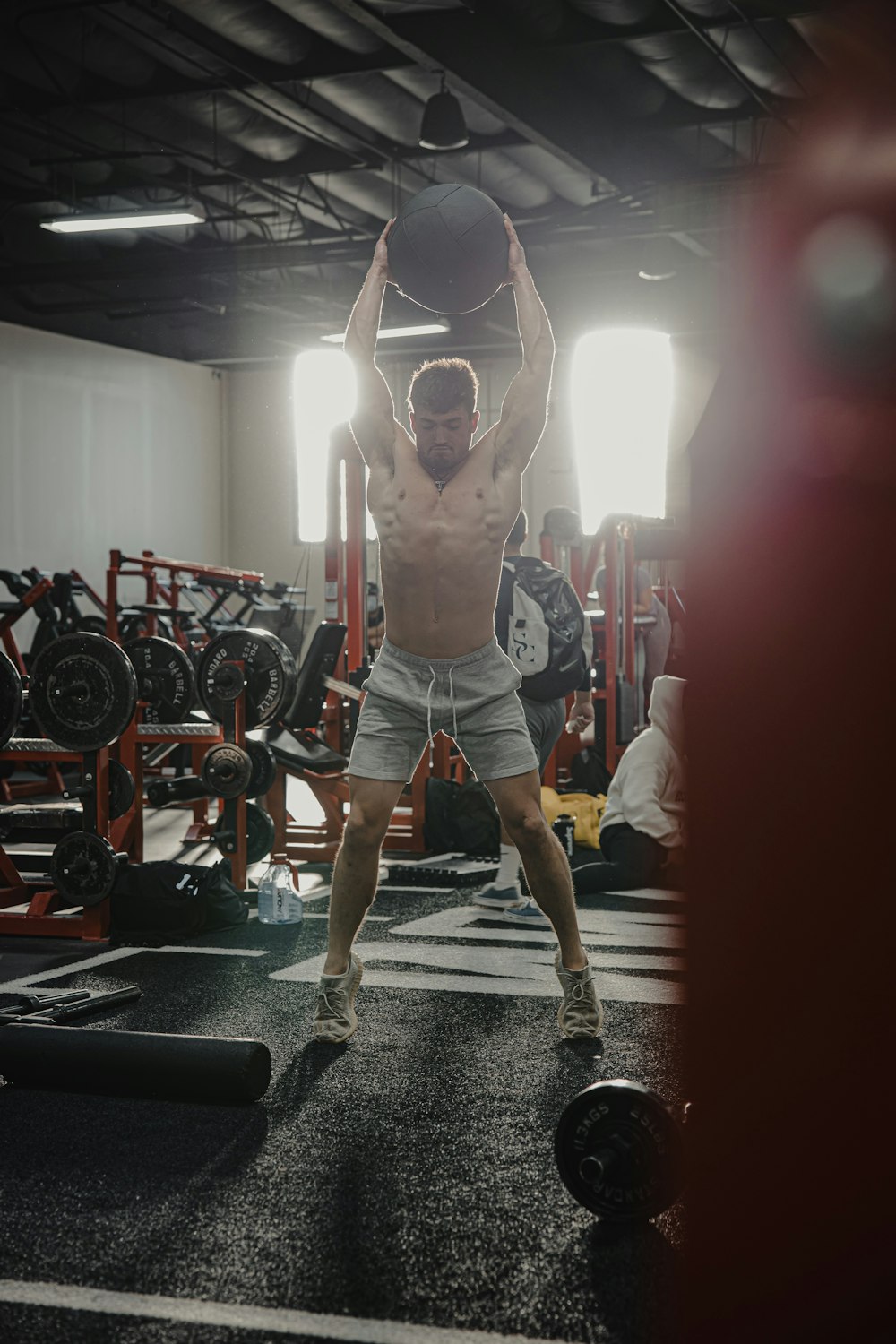 a man lifting a weight in a gym