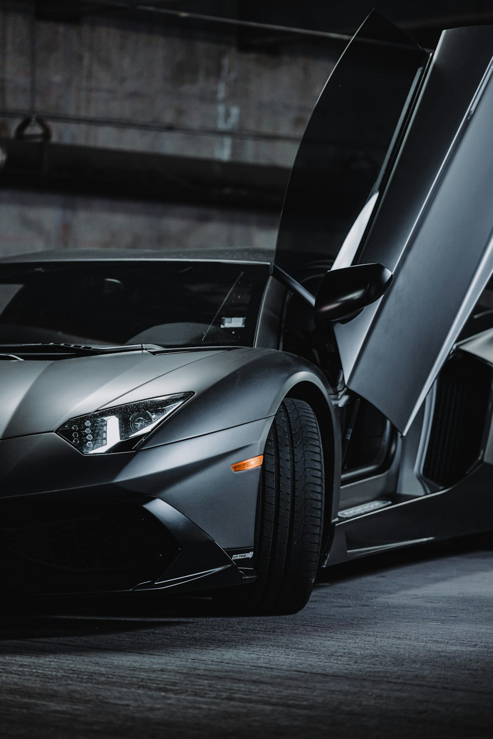 a black sports car parked in a parking garage