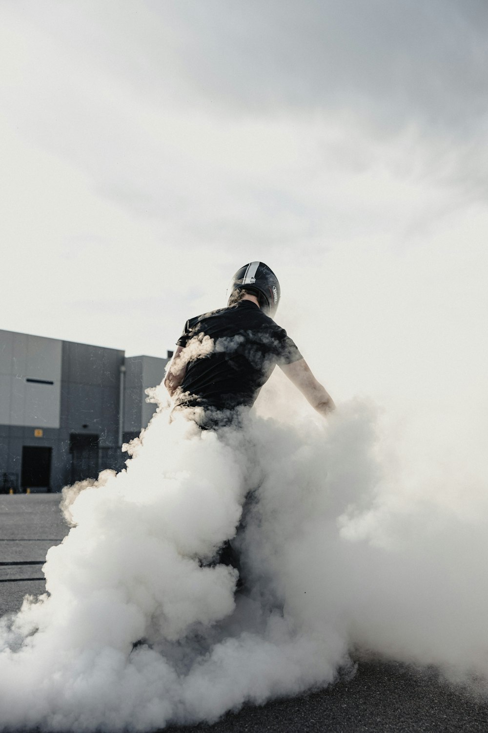 a person on a skateboard riding on a cloud of smoke