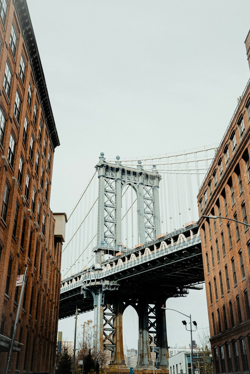 a tall bridge spanning over a river next to tall buildings