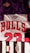 The image features a collection of sports jerseys, including a purple jersey with an emblem, a white jersey with red lettering spelling 'BULLS' and the number 23, and a black and white striped jersey with the Juventus emblem.
