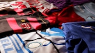 Colorful sublimated jerseys displayed neatly on hangers in a showroom.