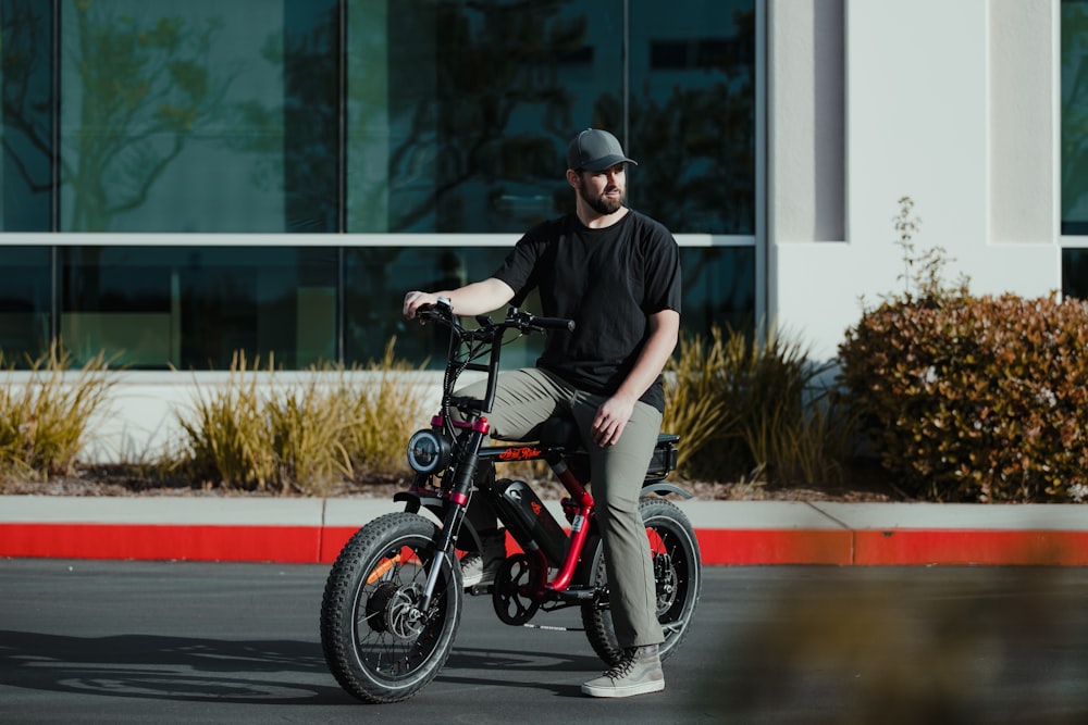 a man sitting on top of a small bike