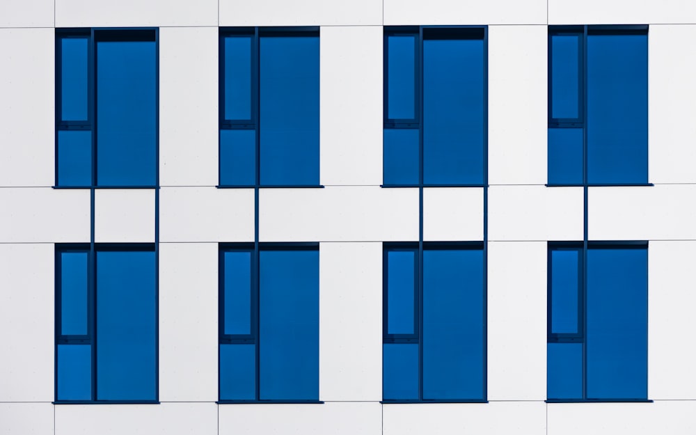 a white and blue building with blue windows