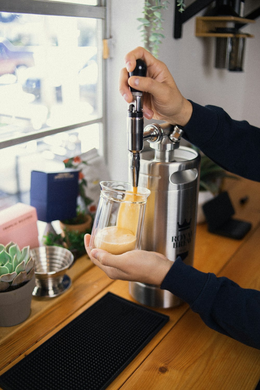 a person is pouring a drink into a glass