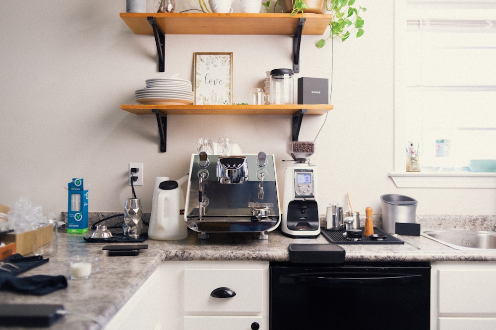 a kitchen counter with a coffee maker and other kitchen items