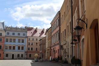 a cobblestone street lined with tall buildings
