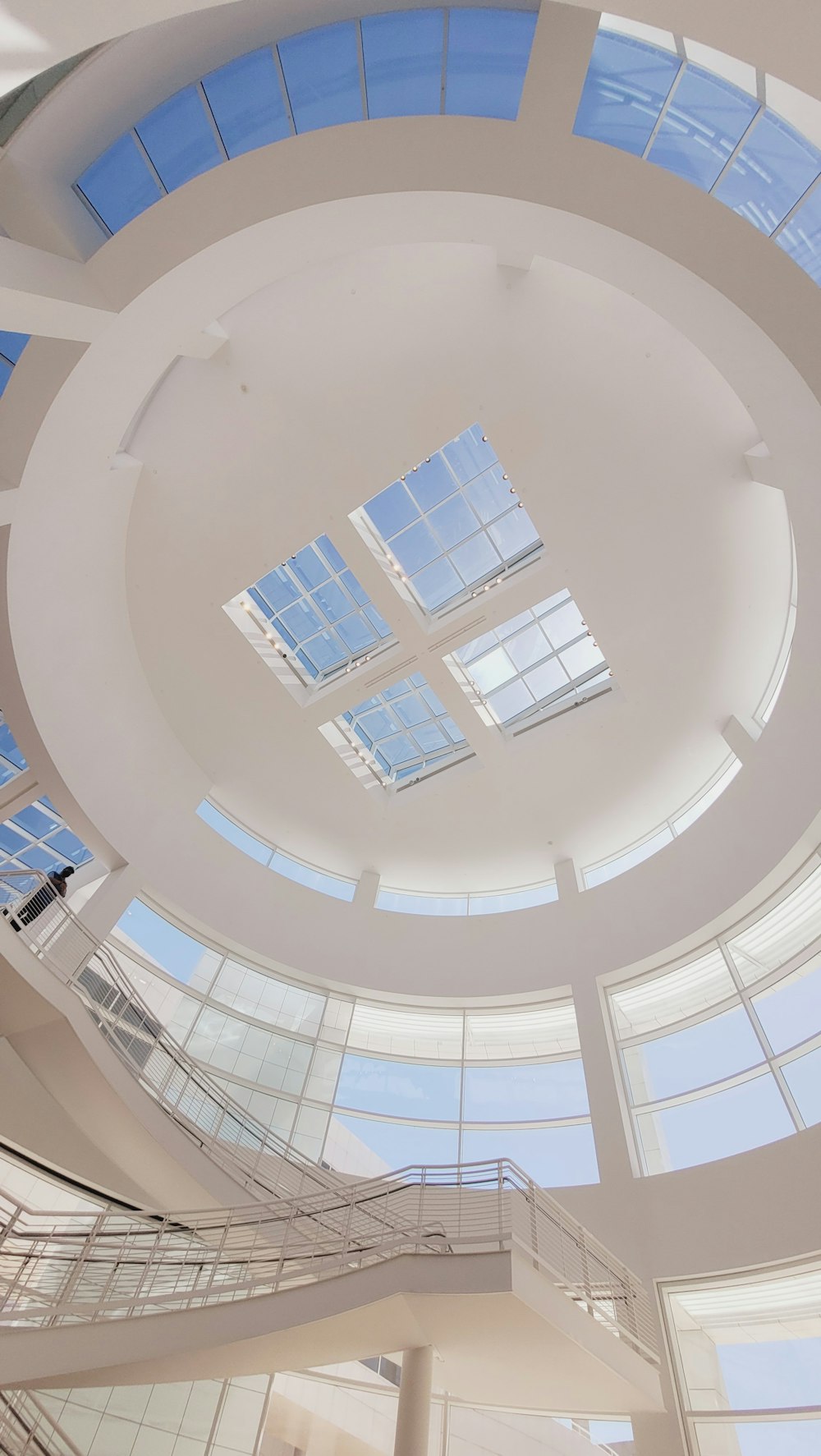 the ceiling of a large building with many windows