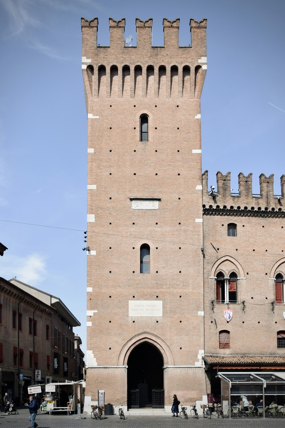 a tall brick tower with a clock on it's side