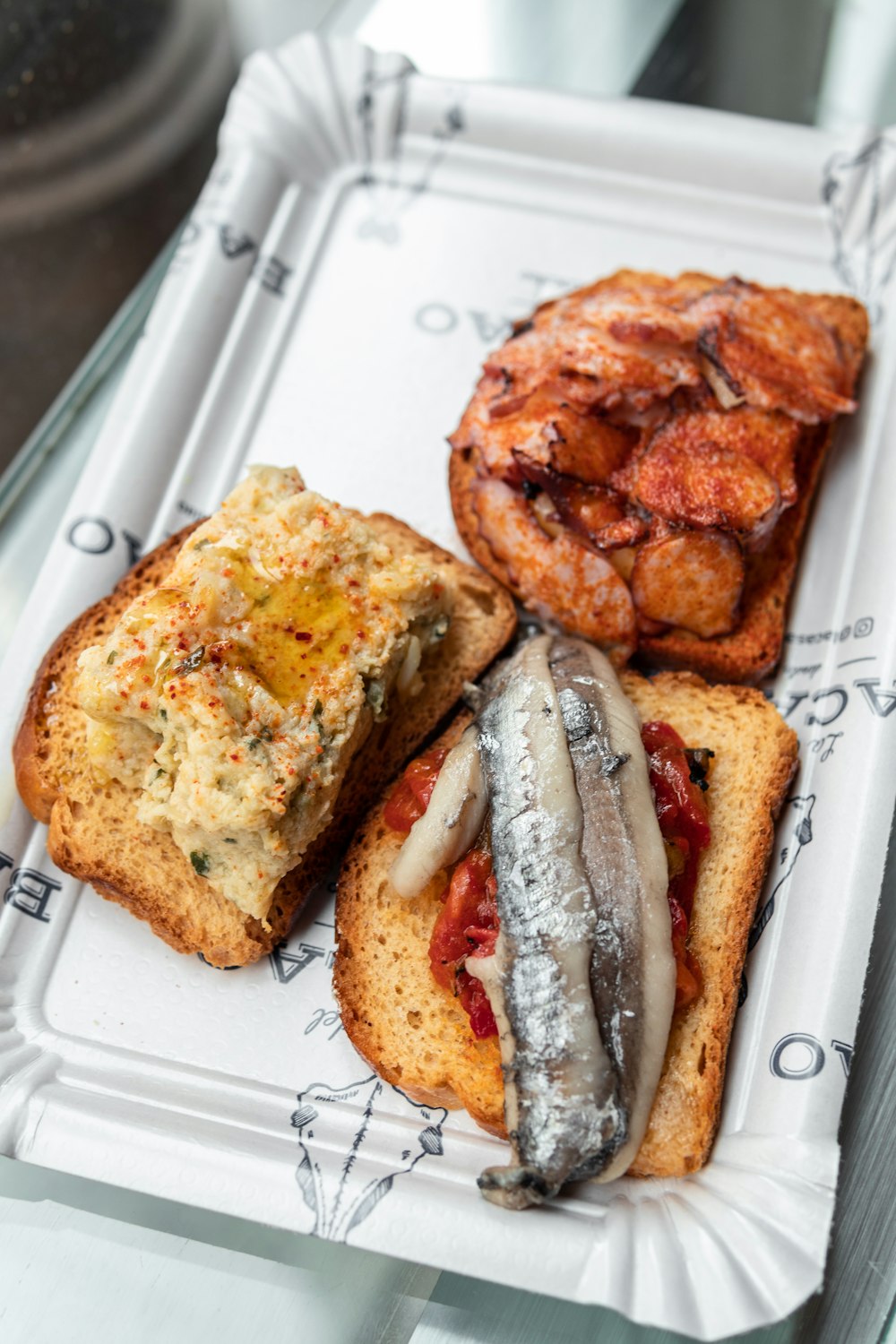 a white tray topped with different types of food