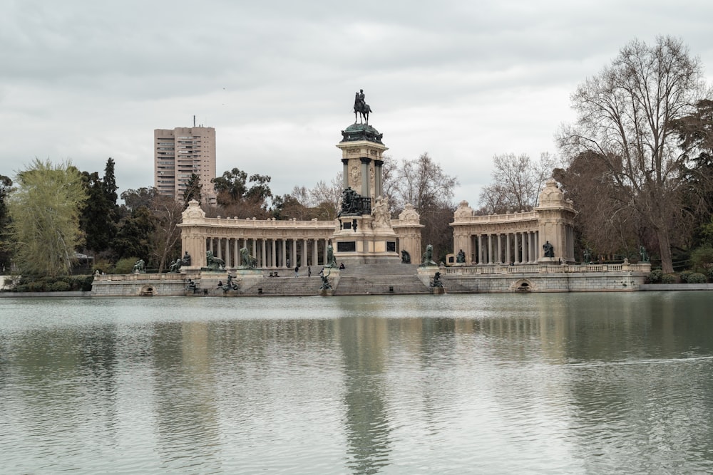 a large body of water with a building in the background