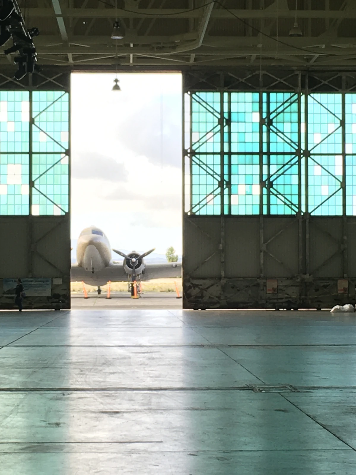 A jetliner inside an aircraft maintenance hangar
