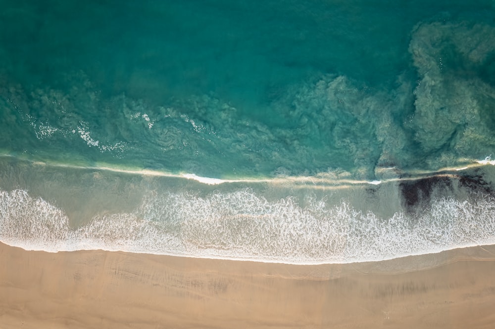 an aerial view of a sandy beach and ocean