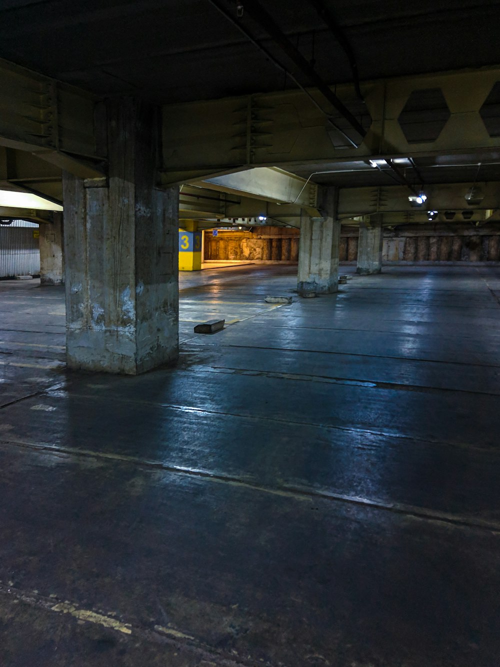 an empty parking garage with a skateboard on the floor