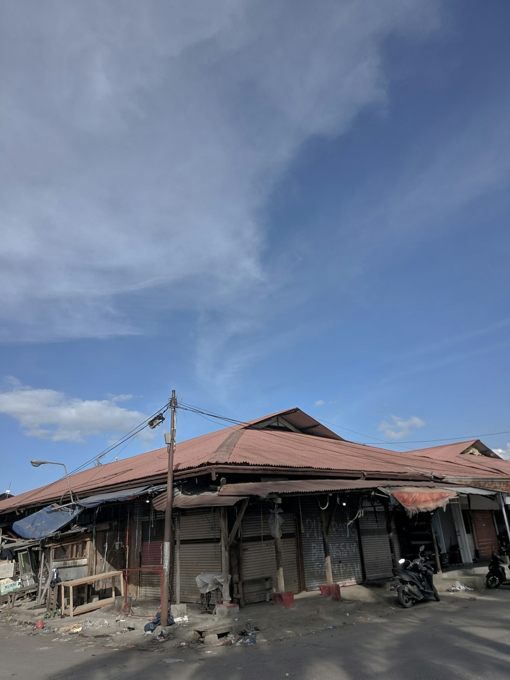 a building with a red roof and a blue sky in the background