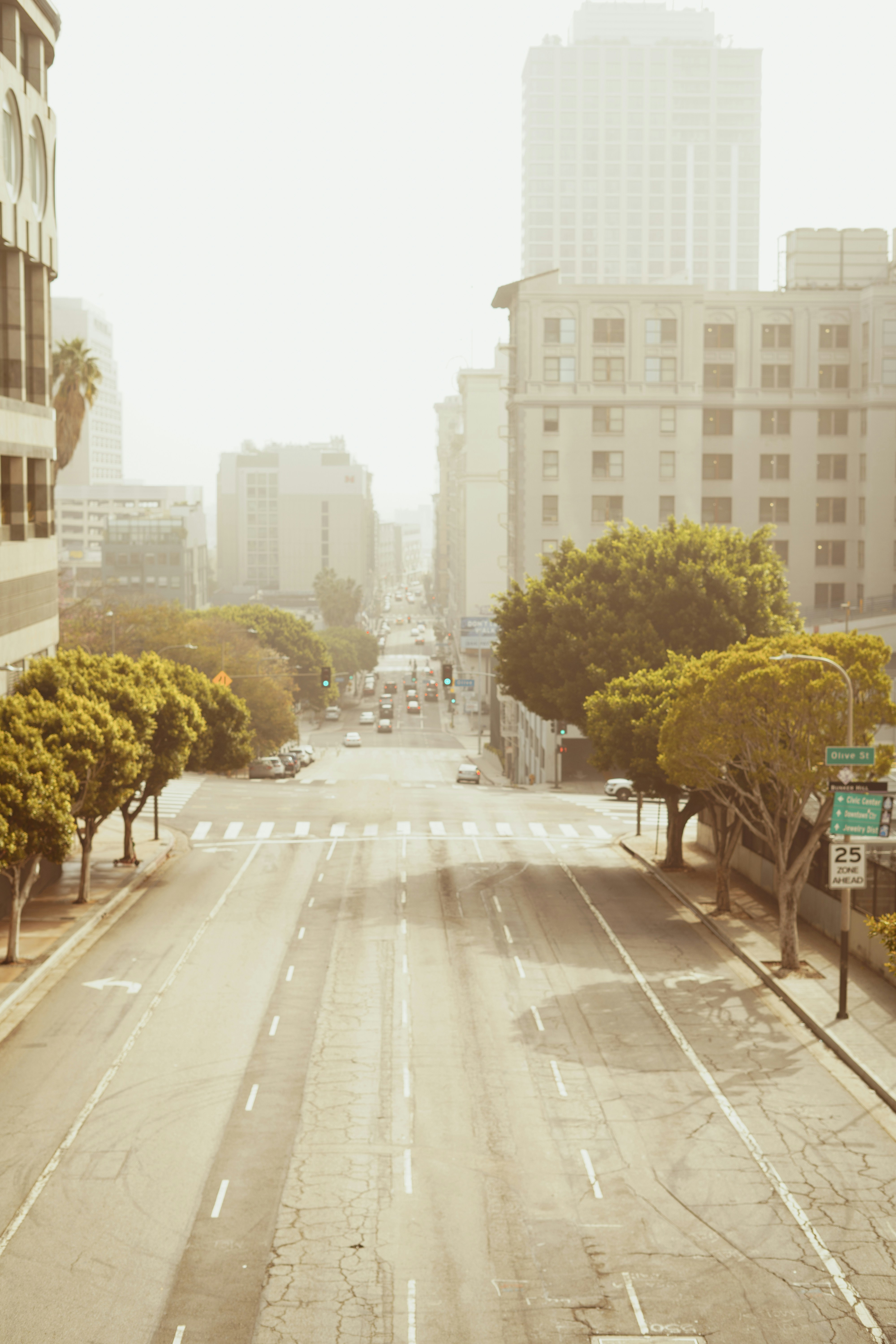 an empty street in a city with tall buildings