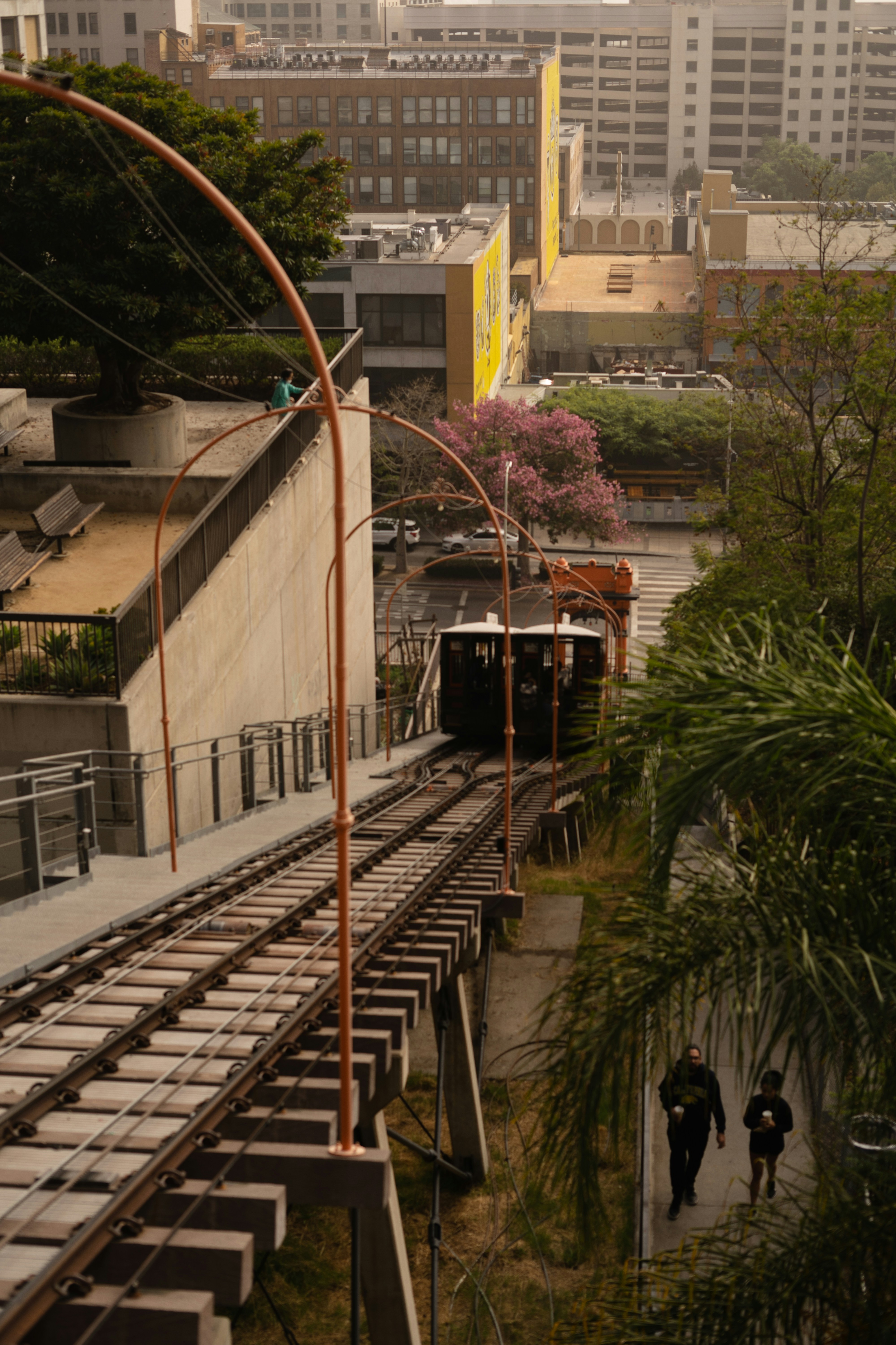 a couple of people walking down a train track