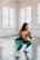 a woman squatting on the floor in a gym
