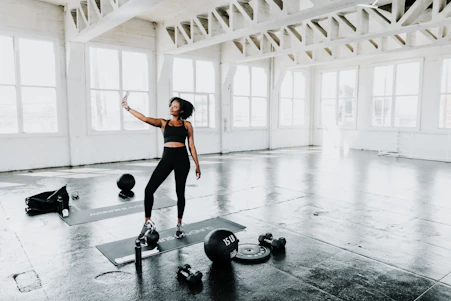 A dynamic fitness influencer collaborating with a wellness brand in a sleek studio setting.