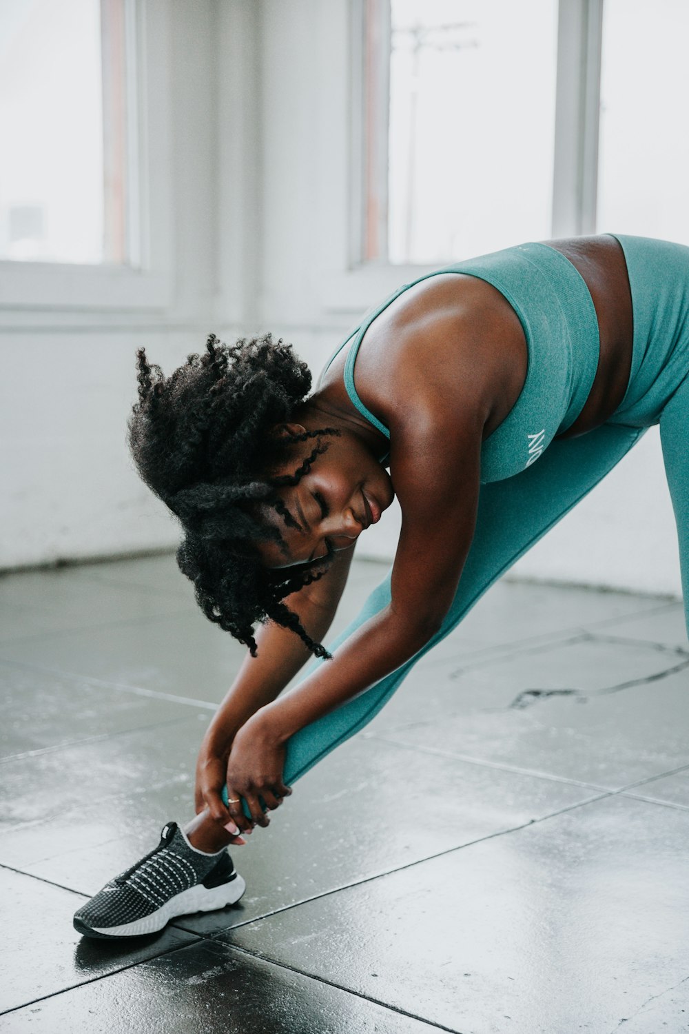 a woman is doing a yoga pose on the floor