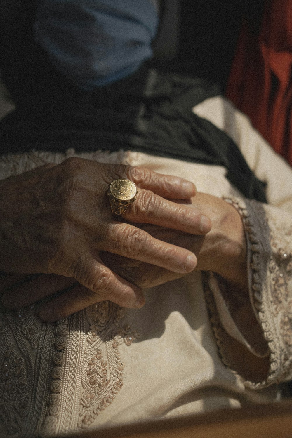 a close up of a person's hand with a ring on it